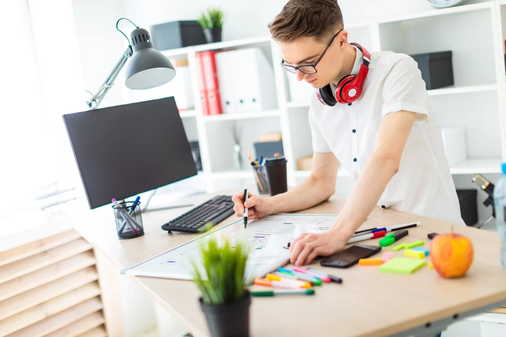 A web designer sketching a layout for a business website to showcase the unique benefits of custom website design