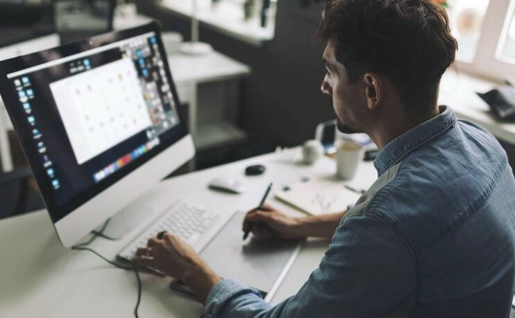 Professional graphic designer using computer for design work