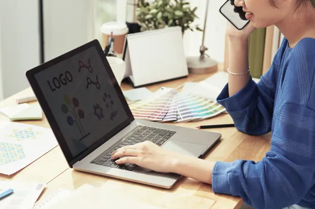 Vector logo design on laptop workspace